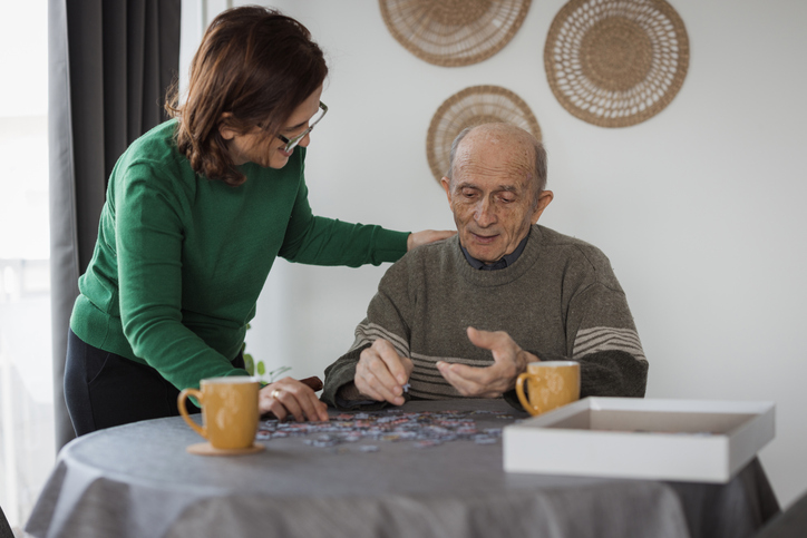 Senior man in memory care doing a puzzle